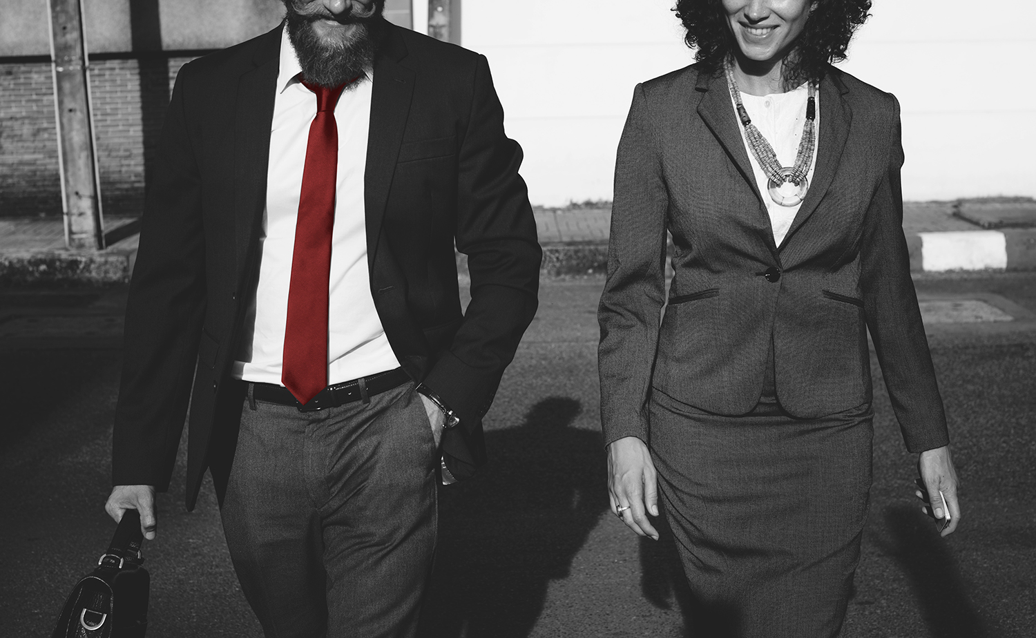 Man and woman in suits walking together